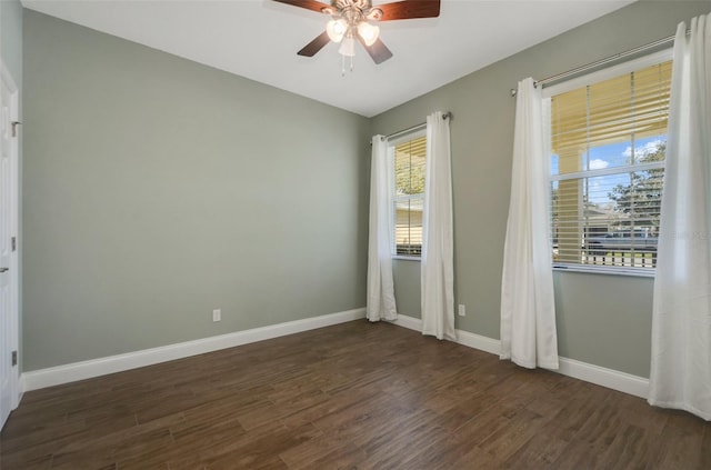 spare room with ceiling fan, baseboards, and wood finished floors