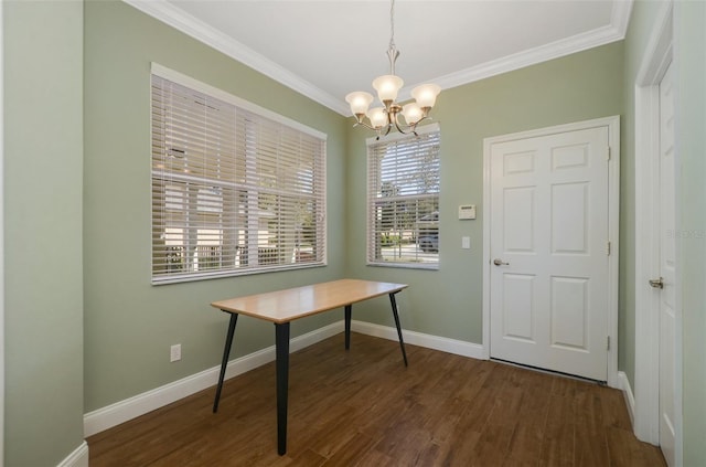 interior space with ornamental molding, an inviting chandelier, wood finished floors, and baseboards