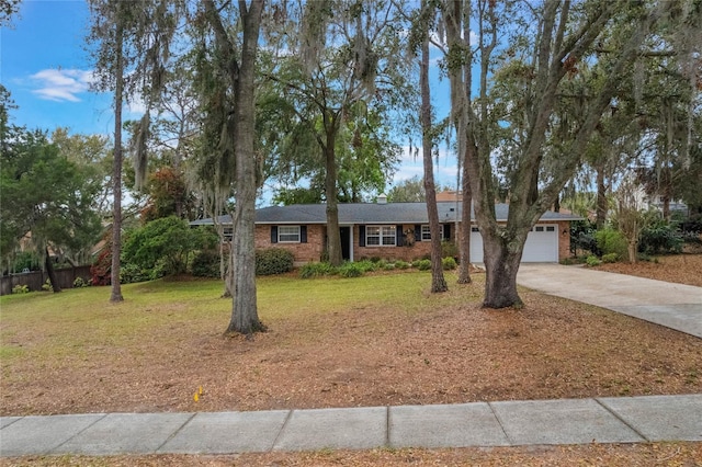 single story home with driveway, an attached garage, fence, a front lawn, and brick siding