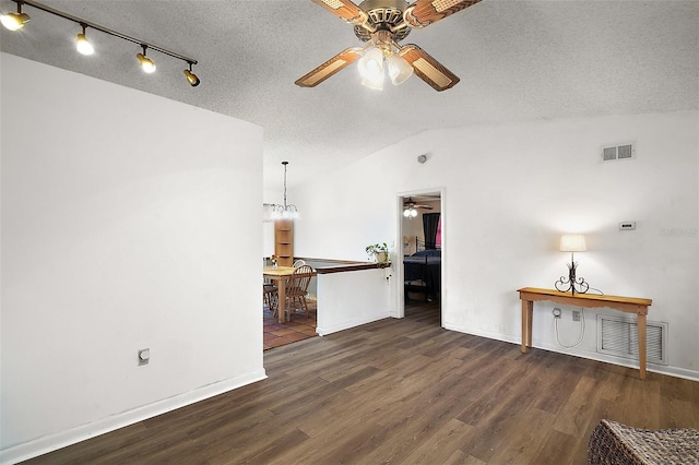 unfurnished living room with lofted ceiling, wood finished floors, and visible vents