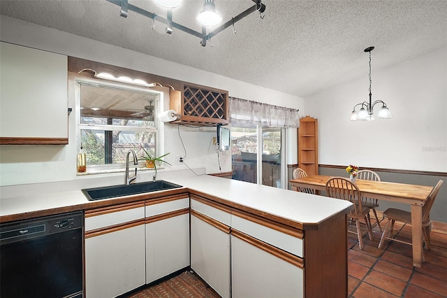 kitchen featuring a peninsula, a sink, white cabinets, light countertops, and dishwasher