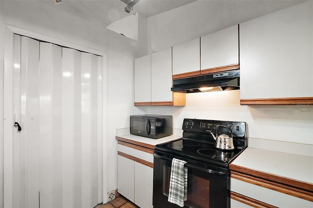 kitchen featuring black appliances, light countertops, white cabinets, and under cabinet range hood