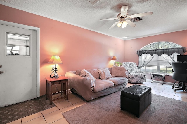 living area with tile patterned flooring, ceiling fan, and a textured ceiling