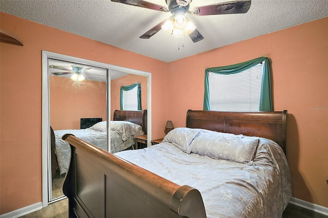 bedroom with a ceiling fan, a closet, a textured ceiling, and baseboards