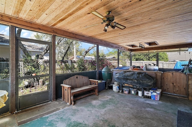 unfurnished sunroom featuring wooden ceiling and ceiling fan