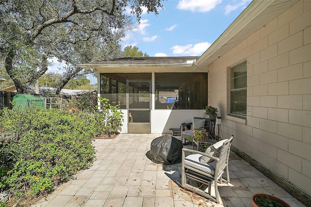 view of patio / terrace featuring a sunroom