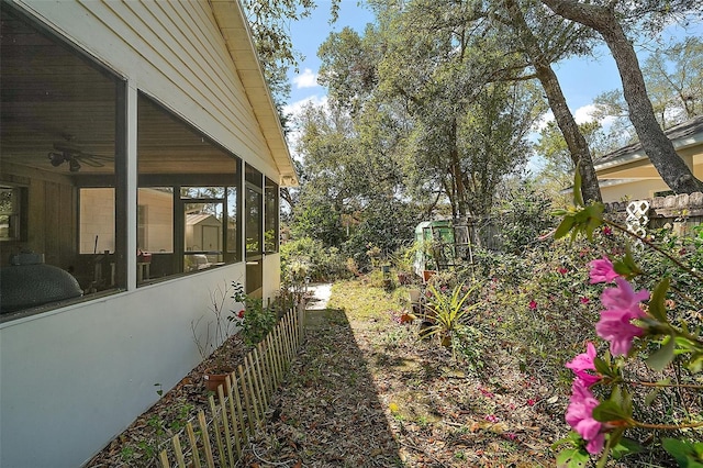 view of yard with a sunroom and fence