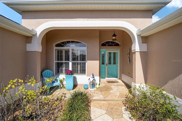 entrance to property featuring stucco siding