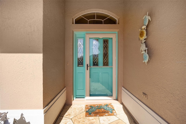 view of exterior entry with stucco siding