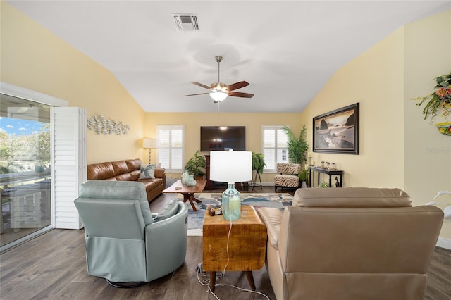 living room with lofted ceiling, visible vents, and wood finished floors