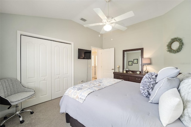 bedroom with visible vents, lofted ceiling, ceiling fan, carpet, and a closet