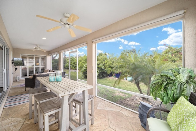 sunroom / solarium with ceiling fan