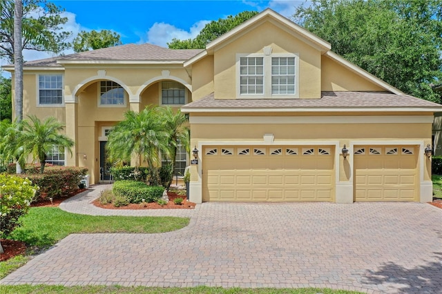 3430 Turningwind Ln, Winter Garden, FL 34787 - view of front of home featuring decorative driveway, stucco siding, and a shingled roof