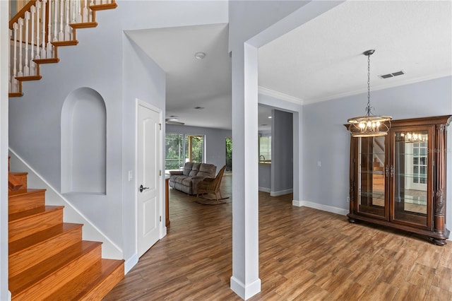 3430 Turningwind Ln, Winter Garden, FL 34787 - foyer with stairs, wood finished floors, baseboards, a chandelier, and ornamental molding