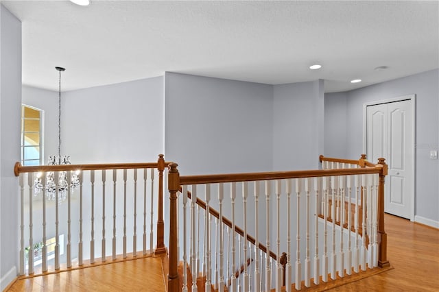 3430 Turningwind Ln, Winter Garden, FL 34787 - corridor with an upstairs landing, wood finished floors, recessed lighting, baseboards, and plenty of natural light