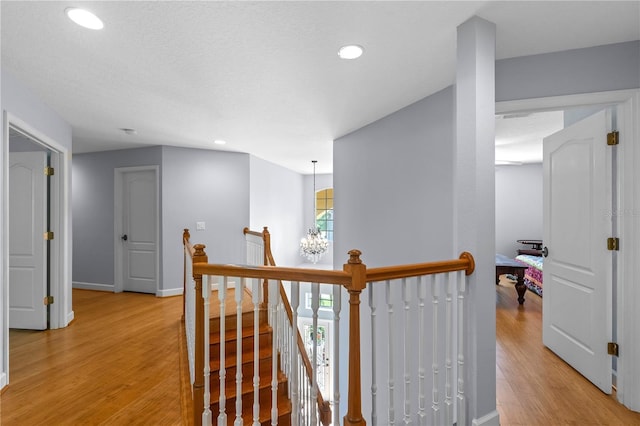 3430 Turningwind Ln, Winter Garden, FL 34787 - hallway featuring an upstairs landing, light wood finished floors, recessed lighting, a chandelier, and baseboards