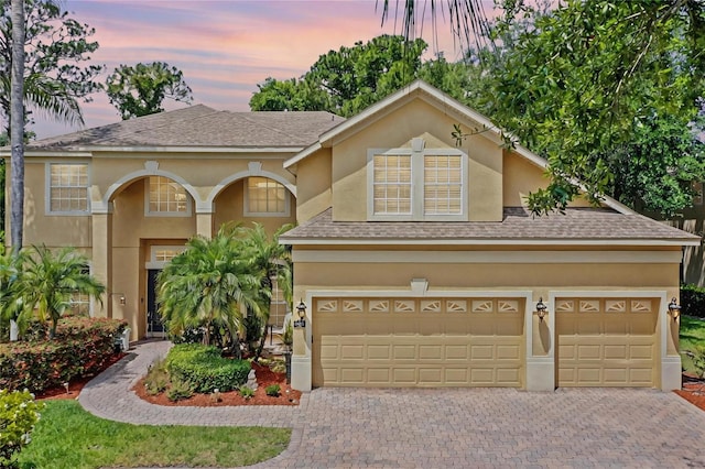3430 Turningwind Ln, Winter Garden, FL 34787 - view of front of property with decorative driveway, stucco siding, and roof with shingles
