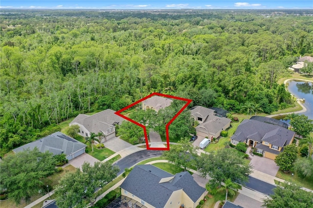 3430 Turningwind Ln, Winter Garden, FL 34787 - aerial view of residential area with a forest, property parcel outlined, and a nearby body of water