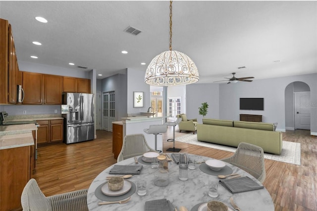 3430 Turningwind Ln, Winter Garden, FL 34787 - dining space featuring wood finished floors, arched walkways, a ceiling fan, and recessed lighting