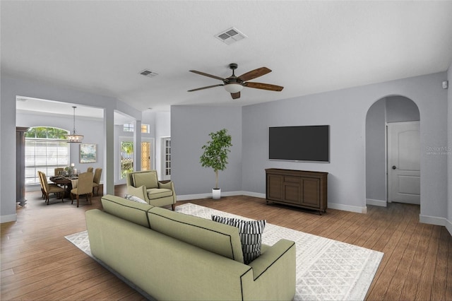 3430 Turningwind Ln, Winter Garden, FL 34787 - living area with arched walkways, ceiling fan, wood-type flooring, and baseboards