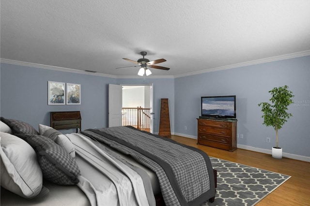 3430 Turningwind Ln, Winter Garden, FL 34787 - bedroom with baseboards, crown molding, wood finished floors, and a ceiling fan