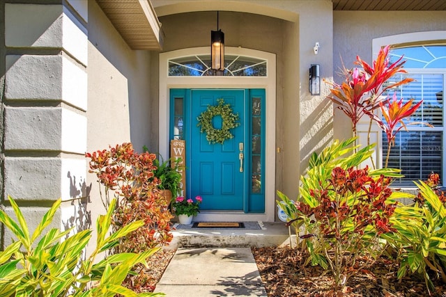 entrance to property featuring stucco siding