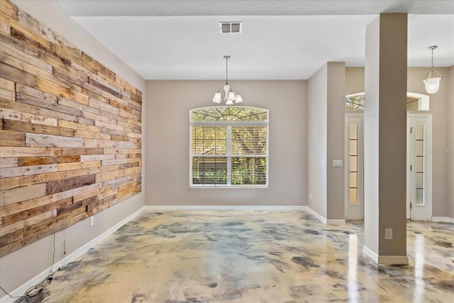 unfurnished dining area with a textured ceiling, a notable chandelier, concrete floors, visible vents, and baseboards