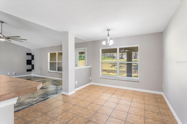 tiled spare room featuring vaulted ceiling, a textured ceiling, baseboards, and ceiling fan with notable chandelier