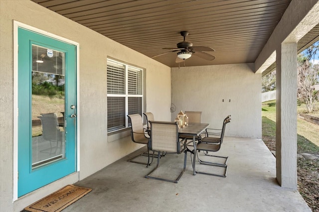 view of patio with outdoor dining area and a ceiling fan