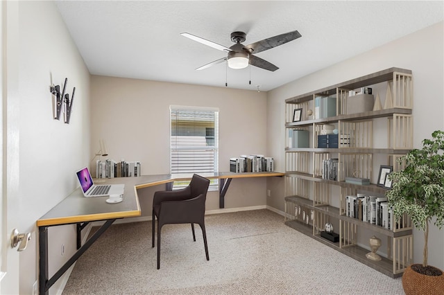 office space featuring a ceiling fan, carpet floors, and baseboards