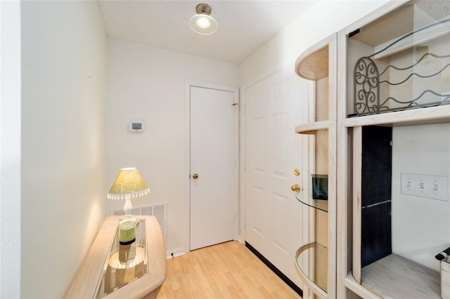 doorway featuring wood finished floors