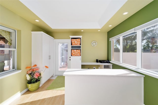 kitchen with light countertops, recessed lighting, light wood-style floors, and a kitchen island