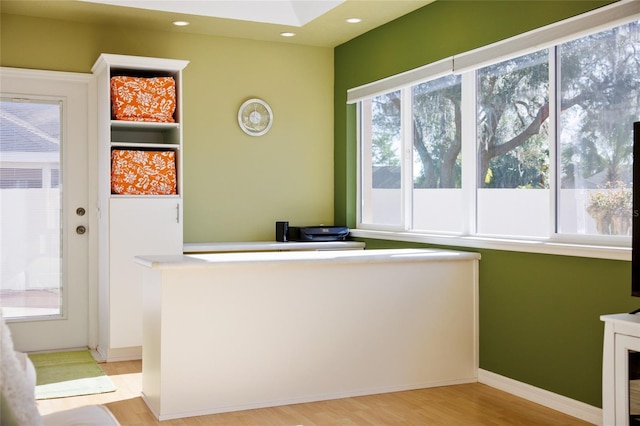 unfurnished office featuring recessed lighting, light wood-type flooring, and baseboards