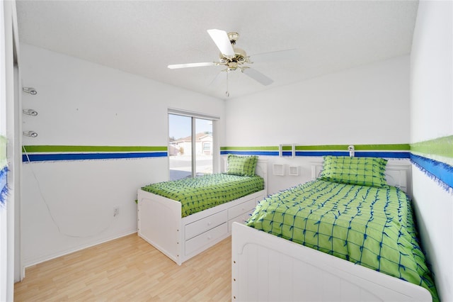 bedroom featuring wood finished floors and a ceiling fan