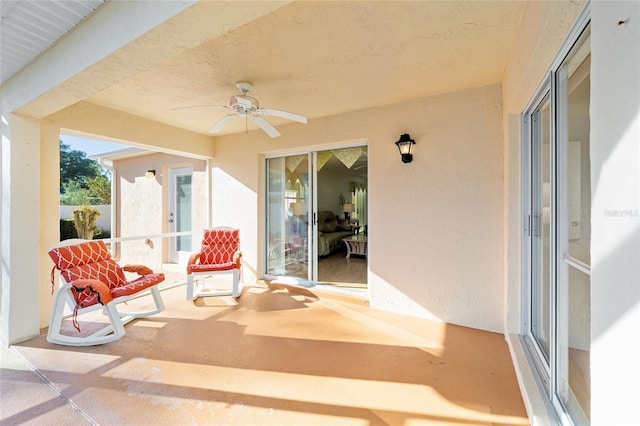 view of patio with a balcony and a ceiling fan