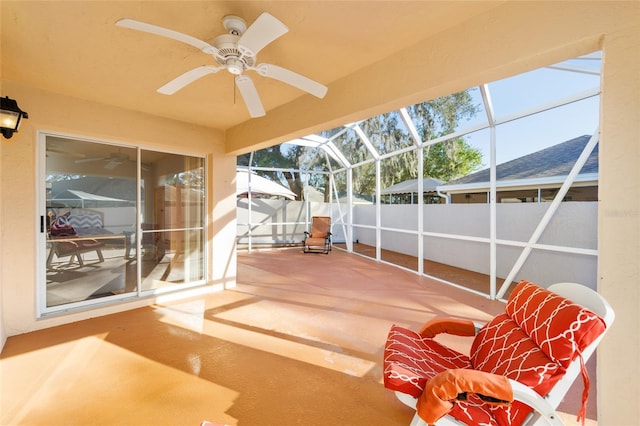unfurnished sunroom with ceiling fan