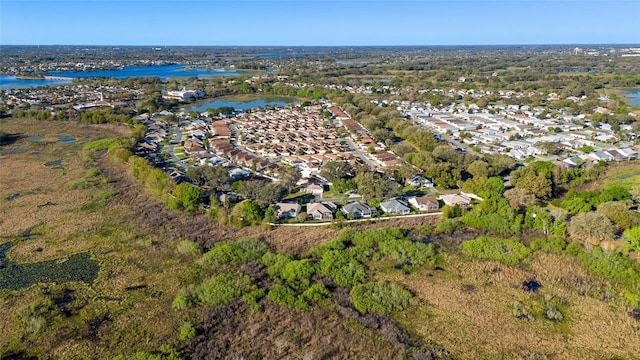 drone / aerial view with a water view and a residential view