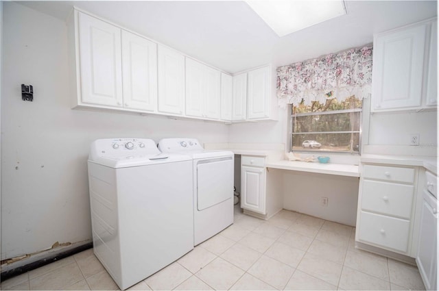 clothes washing area with washing machine and dryer, light tile patterned flooring, and cabinet space