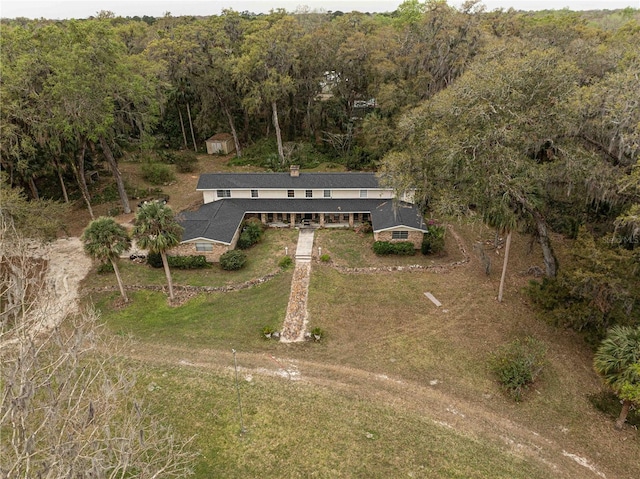 drone / aerial view featuring a forest view