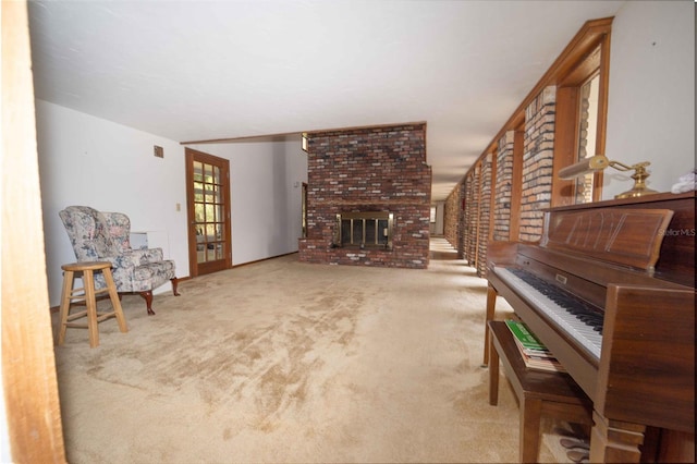 living area featuring a fireplace and carpet flooring