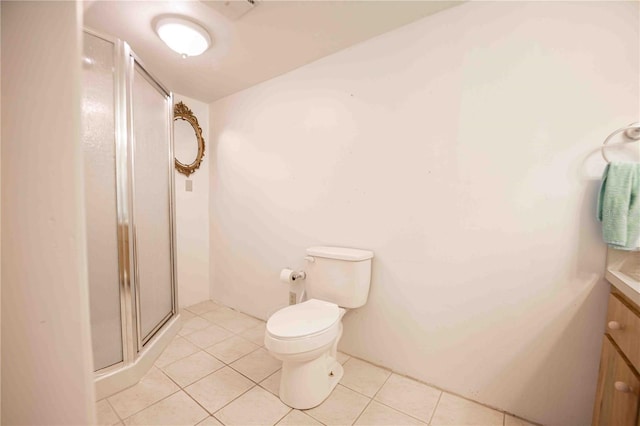 full bath with tile patterned flooring, toilet, vanity, and a stall shower