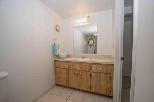 bathroom with tile patterned floors, toilet, and vanity