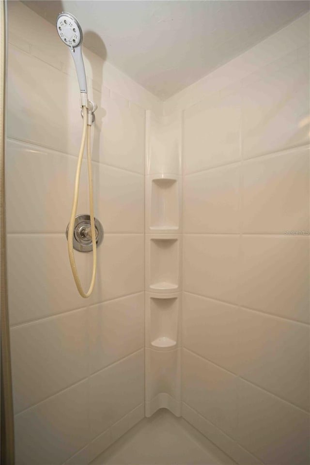 bathroom with tiled shower