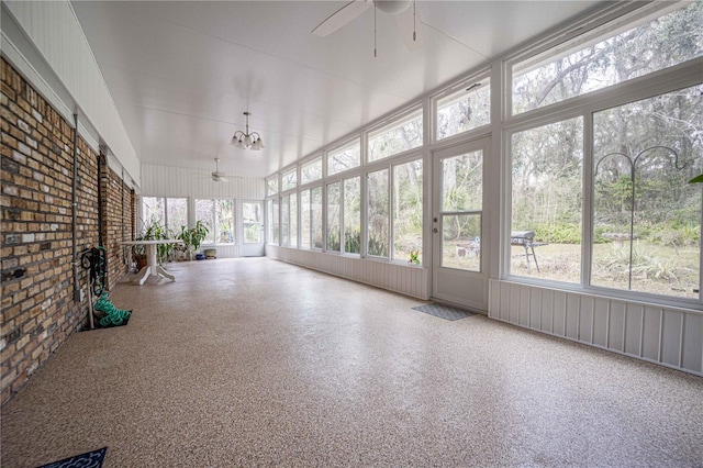 unfurnished sunroom featuring ceiling fan