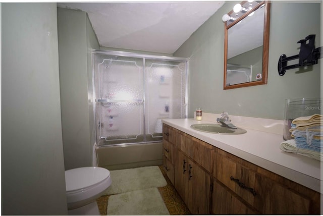 full bathroom with toilet, vanity, and shower / bath combination with glass door