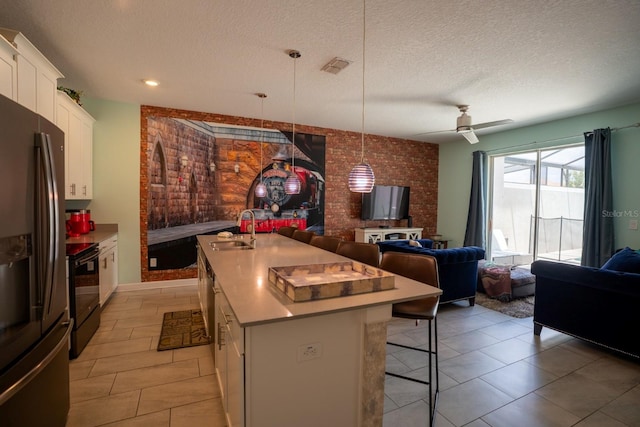 kitchen with black range with electric stovetop, a breakfast bar, a sink, open floor plan, and stainless steel fridge with ice dispenser