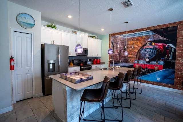 kitchen featuring a center island with sink, visible vents, white cabinets, black appliances, and a sink