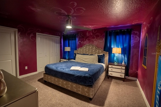 bedroom featuring a textured ceiling, a closet, carpet, and baseboards