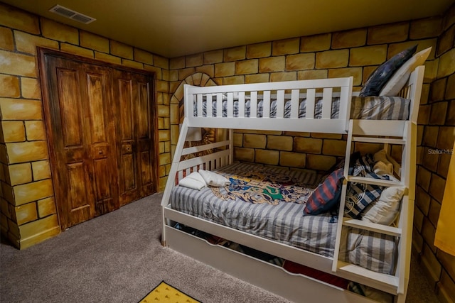 carpeted bedroom featuring visible vents