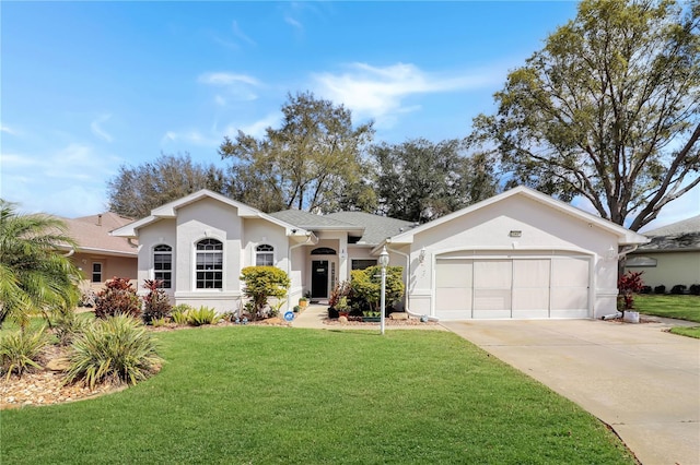 ranch-style home with a garage, concrete driveway, a front lawn, and stucco siding